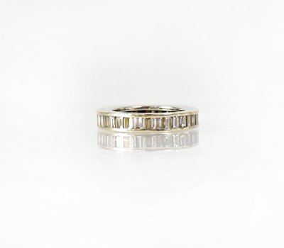 Lot 747 - A white metal eternity ring set with baguette...