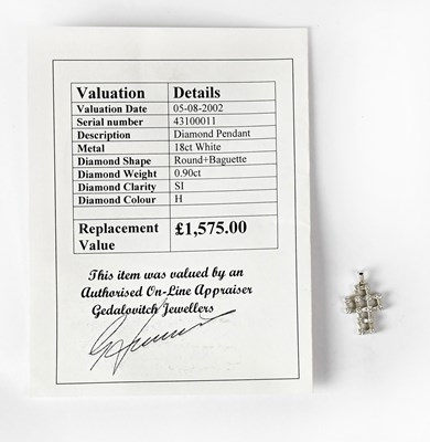 Lot 778 - An 18ct white gold cross pendant set with...