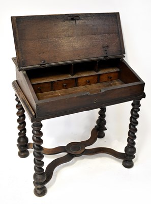 Lot 26 - An 18th century oak clerk's desk on stand, the...