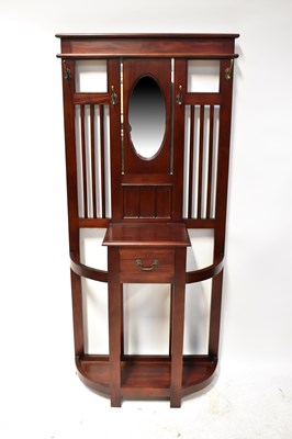 Lot 128 - A mahogany hall stand with central oval mirror...