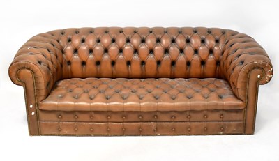 Lot 51 - A brown leather Chesterfield three-seater...