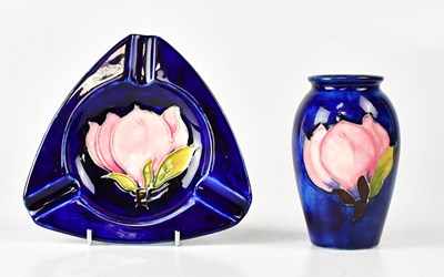 Lot 167 - MOORCROFT; a small blue ground vase and a...