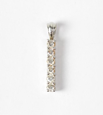 Lot 1080 - An 18ct white gold pendant set with a row of...