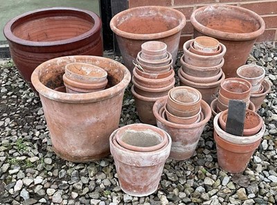 Lot 730 - A quantity of terracotta garden plant pots,...