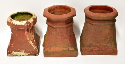 Lot 73 - Three squat terracotta chimney pots, each with...