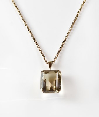 Lot 1090 - A large smoky quartz pendant in a yellow metal...