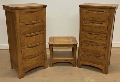 Lot 807 - OAK FURNITURE LAND; two dark oak five drawer...