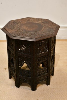 Lot 68 - An Eastern carved octagonal folding table,...