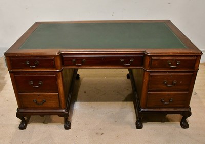 Lot 261 - A mahogany inverted breakfront kneehole desk,...