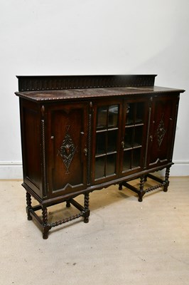 Lot 285 - A 1920s oak bookcase, with raised back above...