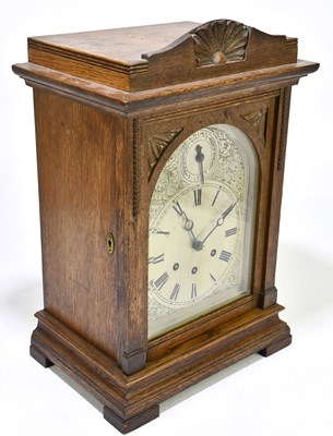 Lot 2633 - An Edwardian oak cased mantel clock, the...