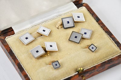 Lot 1212 - A cased set of mother of pearl and sapphire...