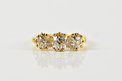 Lot 1274 - An Edwardian 18ct yellow gold three stone...