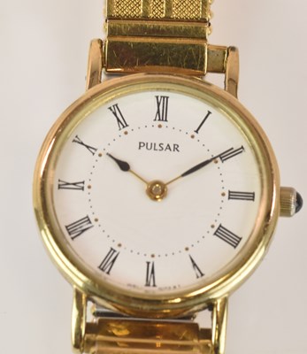 Lot 667 - PULSAR; a lady's gold plated stainless steel...