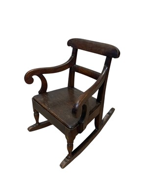 Lot 318 - A 19th century child's elm seated rocking chair.