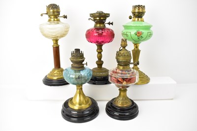 Lot 102 - Five 19th century paraffin lamps, height of...