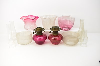 Lot 99 - Two 19th century cranberry glass paraffin...