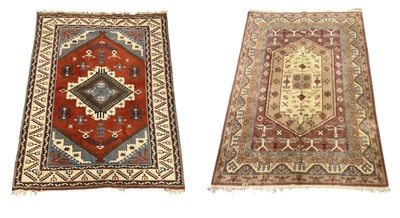 Lot 105 - Two Persian red ground carpets with geometric...