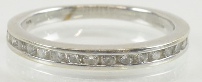 Lot 1302 - A 14ct white gold diamond set half eternity...