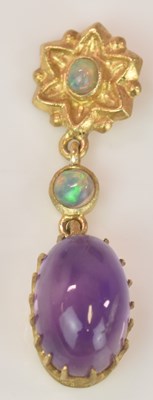 Lot 597 - A yellow metal amethyst and opal pendant, the...