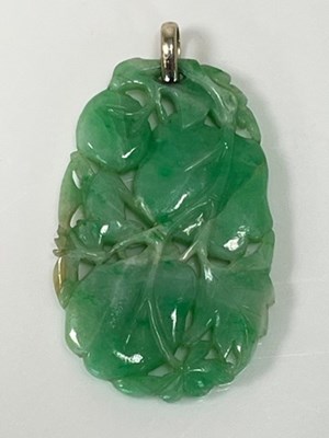 Lot 253 - A Chinese jade pendant, with white metal loop...