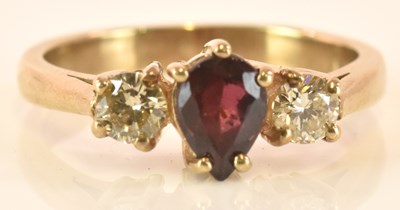 Lot 521 - A 9ct yellow gold three stone ruby and diamond...