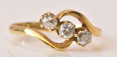 Lot 560 - An 18ct yellow gold diamond three stone ring,...