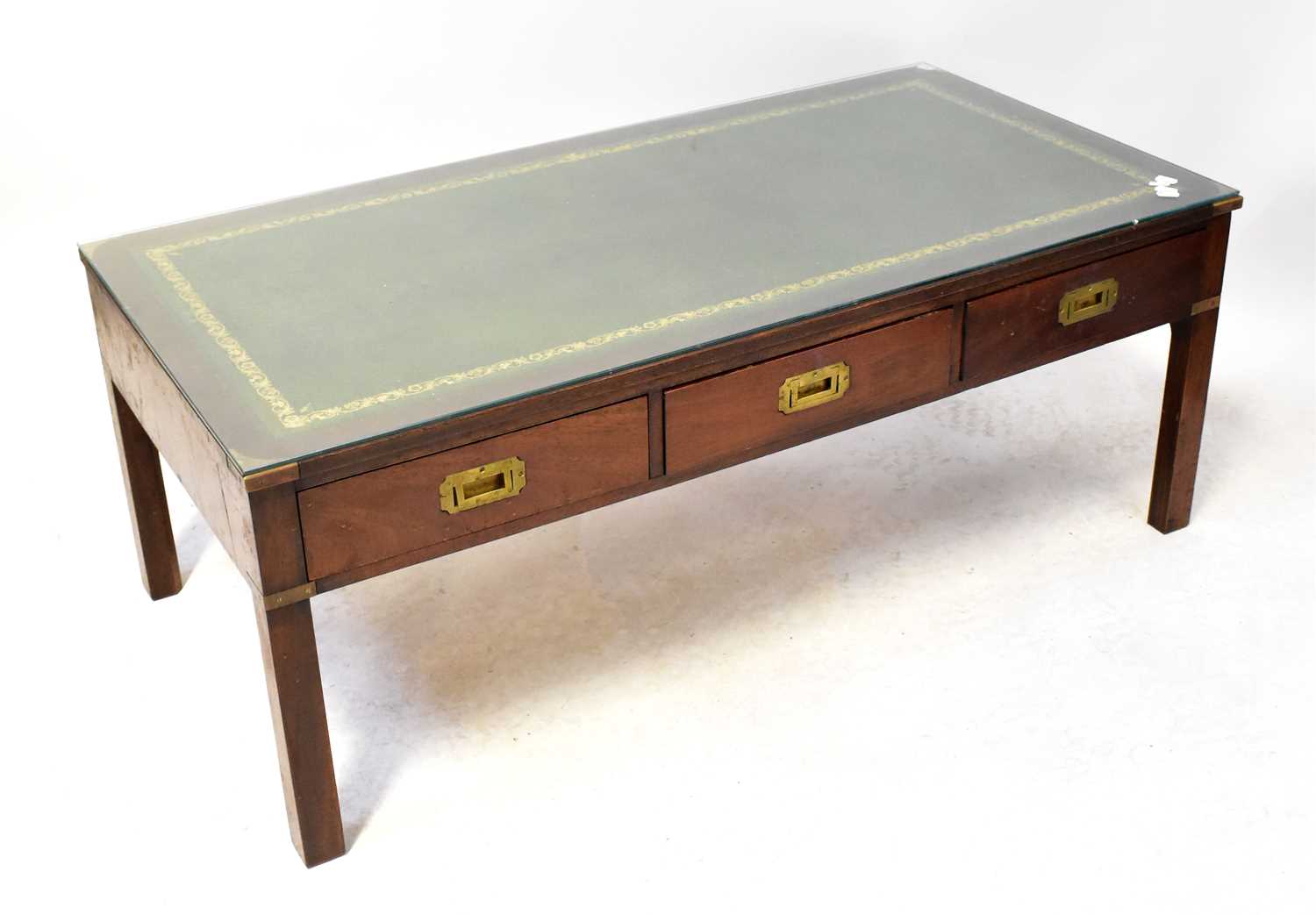 Lot 42 - A mahogany coffee table with gilt tooled green...