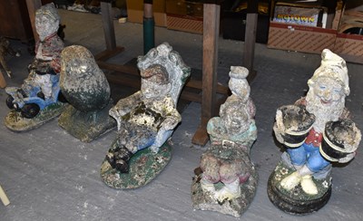 Lot 415 - Four large garden gnomes and a large owl.