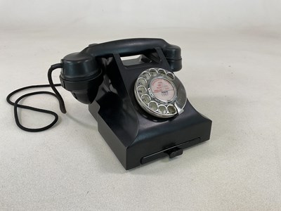 Lot 19 - A black Bakelite telephone with index drawer...