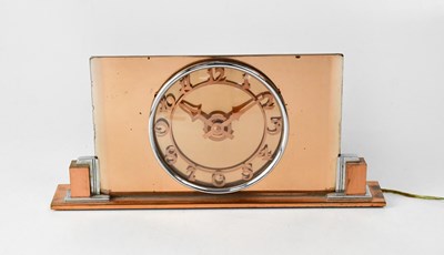 Lot 116 - An Art Deco peach glass mantel clock, the dial...