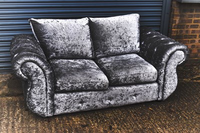 Lot 64 - A grey velvet two seater settee with scrolling...