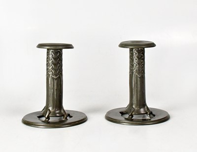 Lot 235 - TUDRIC; a pair of pewter candlesticks by...