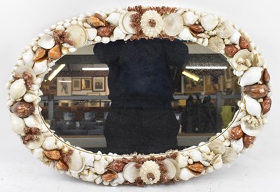 Lot 74 - An unusual oval mirror decorated with applied...