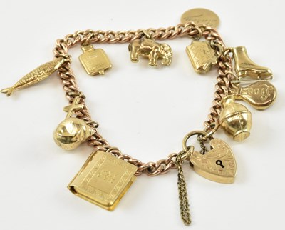 Lot 807 - A 9ct yellow gold charm bracelet with eleven...