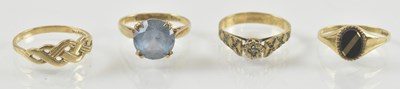 Lot 946 - Four 9ct gold rings with various mounts...