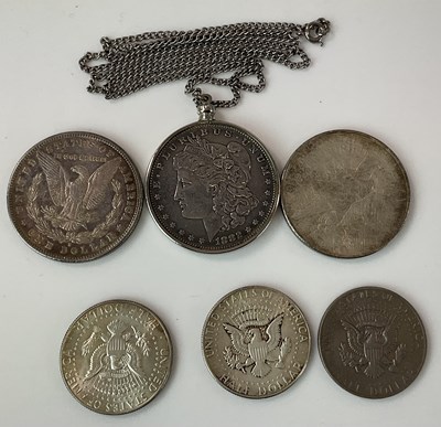 Lot 411 - An 1882 silver dollar on chain, 1924 dollar,...