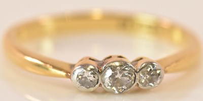 Lot 588 - An 18ct yellow gold three stone graduated...