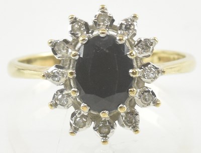 Lot 919 - A 9ct gold diamond and sapphire set ring, the...