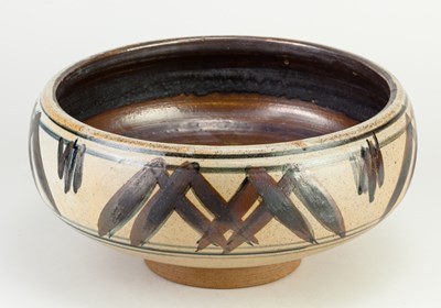 Lot 803 - A large stoneware rose bowl partially covered...