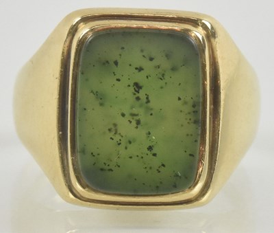 Lot 842 - A 10k gold signet ring, with bevelled green...