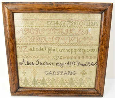 Lot 502 - A mid Victorian sampler featuring the alphabet...