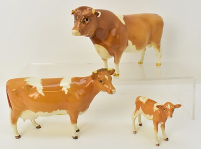 Lot 623 - BESWICK; a family of three Guernsey cattle...