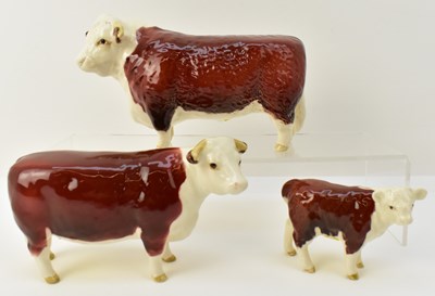 Lot 625 - BESWICK; a family of three Hereford cattle...