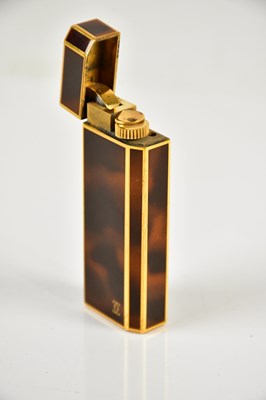 Lot 587 - CARTIER; a tortoiseshell effect cigarette...