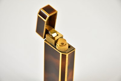 Lot 587 - CARTIER; a tortoiseshell effect cigarette...