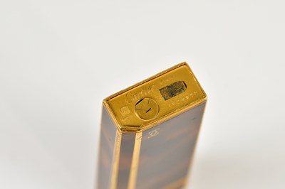 Lot 587 - CARTIER; a tortoiseshell effect cigarette...