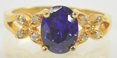 Lot 911 - A 14kt amethyst and white stone dress ring,...