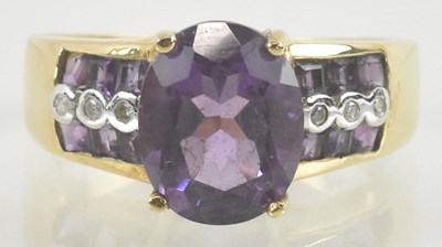 Lot 927 - A 10k gold amethyst and diamond dress ring,...