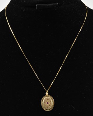 Lot 931 - A 9ct gold oval necklace pendant set with...